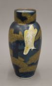 A late 19th/early 20th century Japanese blue ground pottery vase with gilt heightening and