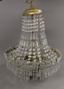 A brass and cut glass chandelier. Approximately 75 cm high.