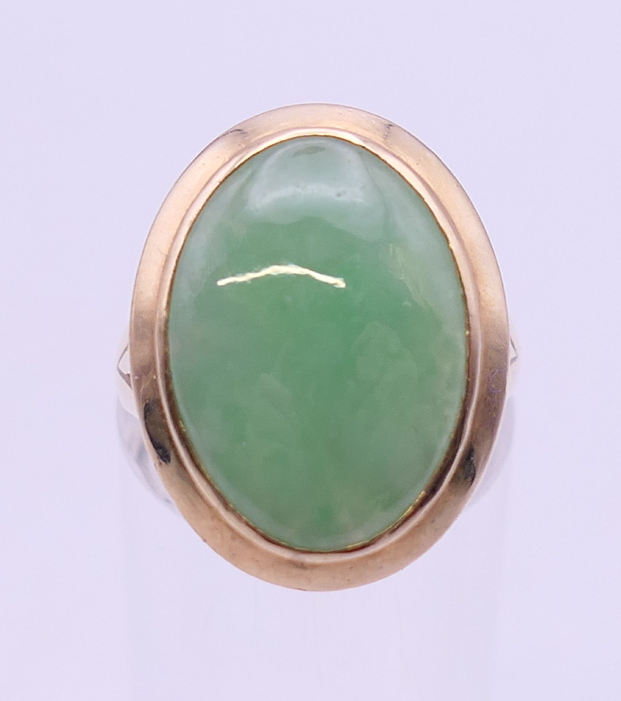 A 14 ct gold jade ring. Ring size N.