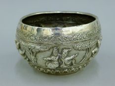 An Indian unmarked white metal bowl with repousse decoration. 11 cm high. 530.6 grammes.