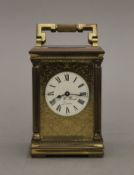 A carriage clock, the dial inscribed 'J W Benson London'. 14 cm high.