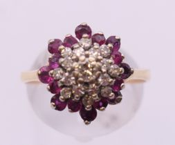 A 14 ct gold ruby and diamond cluster ring. Ring size R/S.