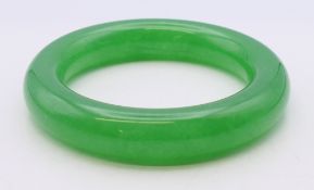 An apple green bangle. Approximately 5.5 cm internal diameter.