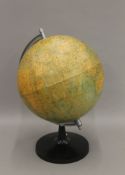 A large terrestrial revolving globe on a bakelite base. 48 cm high.