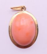 A 14 K gold and coral pendant. 3.25 cm high.