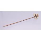 A gold and diamond stick pin, boxed. 5.5 cm long. 1.2 grammes total weight.