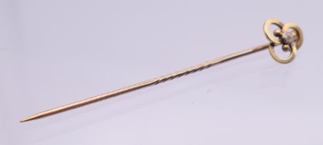 A gold and diamond stick pin, boxed. 5.5 cm long. 1.2 grammes total weight.