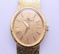 A boxed 18 ct gold Baume & Mercier ladies wristwatch (with one additional link). 2.25 cm wide. 41.