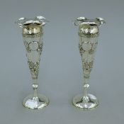 A pair of 19th century Chinese silver trumpet vases decorated with flowers, maker W.N. 18.5 cm high.