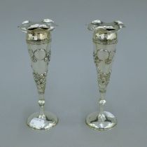 A pair of 19th century Chinese silver trumpet vases decorated with flowers, maker W.N. 18.5 cm high.