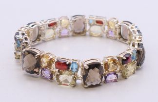 A silver multi-gem bracelet. 18 cm long.