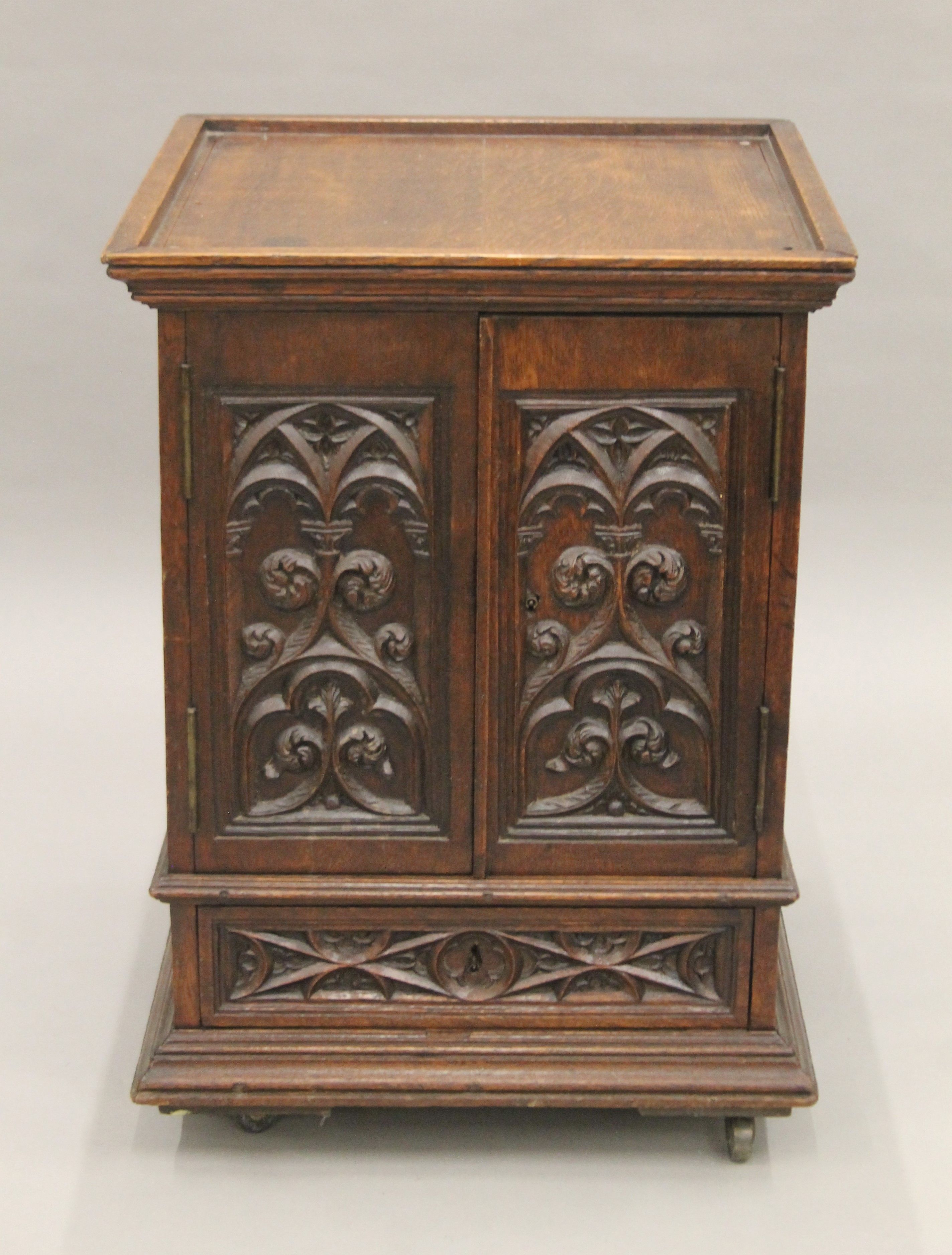 A small Victorian carved oak Gothic Revival cabinet with base drawer. 51.5 cm square.