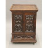 A small Victorian carved oak Gothic Revival cabinet with base drawer. 51.5 cm square.