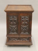 A small Victorian carved oak Gothic Revival cabinet with base drawer. 51.5 cm square.