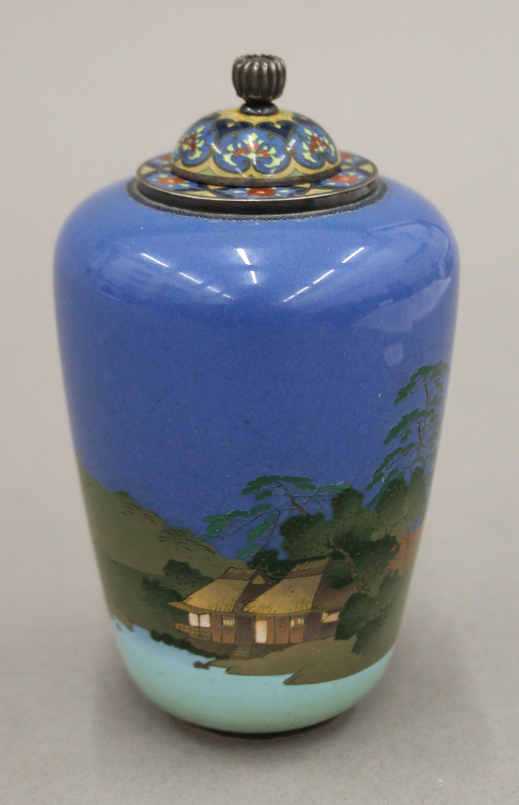 An early 20th century Japanese silver and cloisonne enamel lidded vase decorated with shoreline