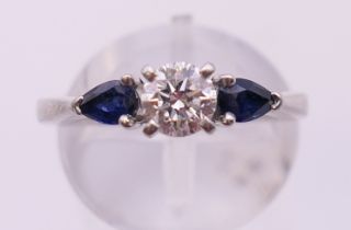 A platinum diamond and sapphire three stone ring. Ring size K/L.