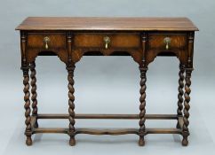 An oak barley twist three drawer side table. 105 cm wide.