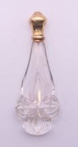 A French 18 ct gold topped glass scent bottle. 12 cm high.