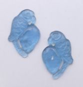 Two pendants carved as parrots. Each 3 cm high.
