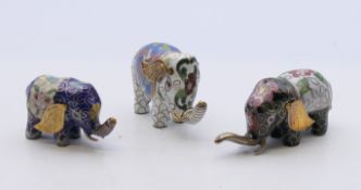 Three cloisonne elephants. The largest 3.5 cm high.