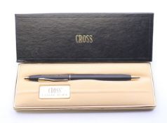 A boxed Cross ballpoint pen.