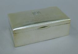 A Chinese silver cigarette box with presentation inscription. 16 cm wide.