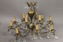 An eight branch brass and glass drop chandelier. 47 cm high.
