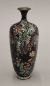 A late 19th/early 20th century Japanese cloisonne vase decorated with foliage. 18 cm high.