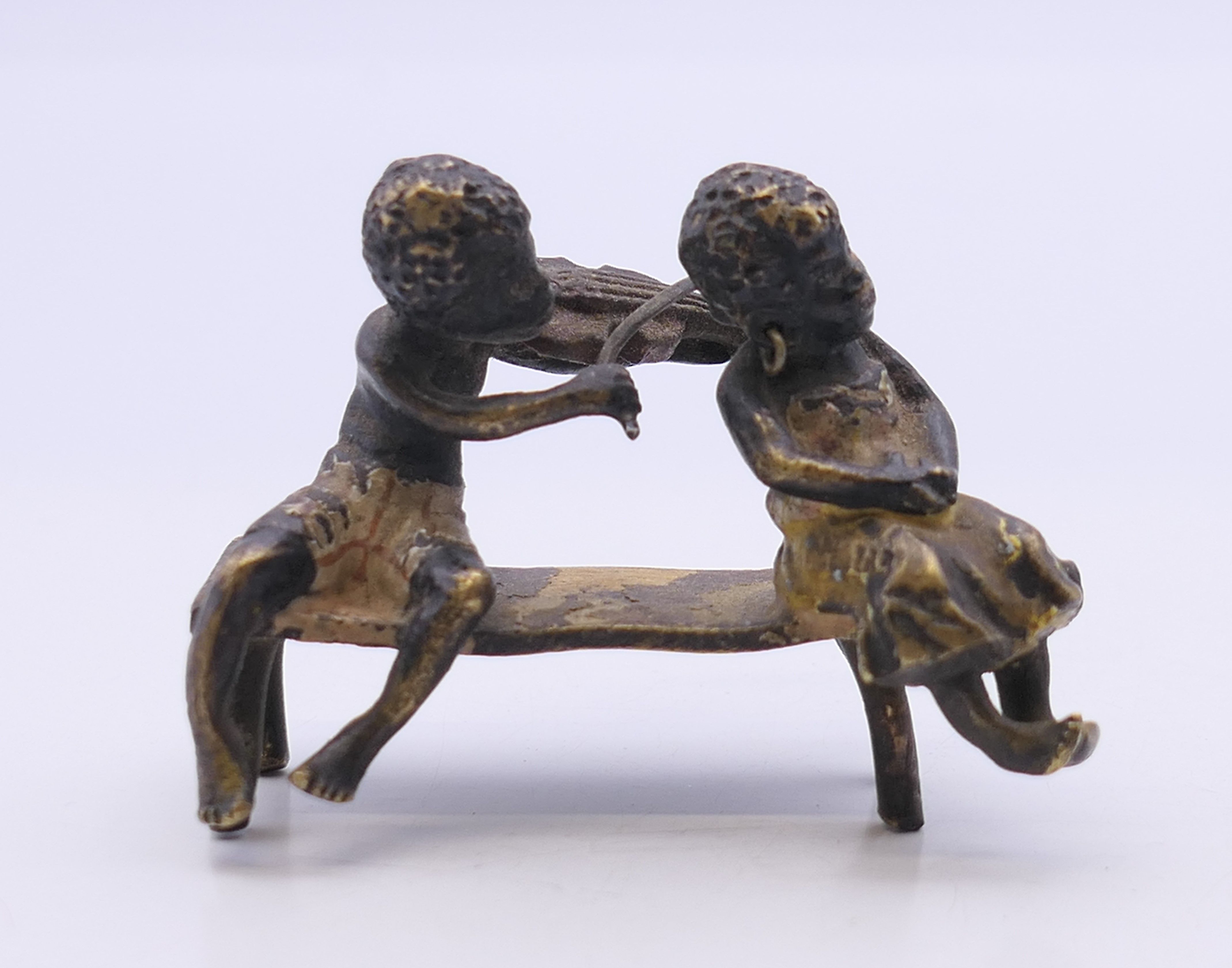 A 19th century Austrian cold painted bronze model formed as two figures seated on a bench, - Image 2 of 4