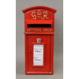 A red post box. 58 cm high.