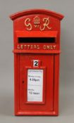 A red post box. 58 cm high.