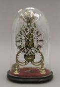 A brass skeleton clock under a glass dome. 40 cm high overall.