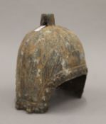 A bronze helmet, possibly Chinese. 31 cm high.