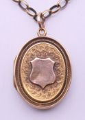 An Edwardian unmarked gold locket on a 9 ct gold chain. The locket 2.5 cm high. 15.7 grammes.