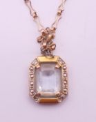 A 9 ct gold pendant on chain. The pendant 1.5 cm high.