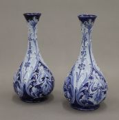 A pair of William Moorcroft Macintyre Florianware vases. 20 cm high.