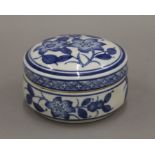 A Chinese blue and white porcelain lidded pot decorated with flowers. 12.5 cm diameter.