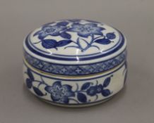 A Chinese blue and white porcelain lidded pot decorated with flowers. 12.5 cm diameter.