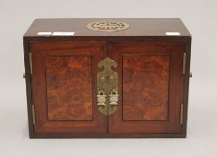 A Chinese hardwood table top cabinet with four drawers. 32 cm wide.