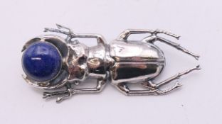 A silver and lapis scarab brooch. 5.5 cm long.