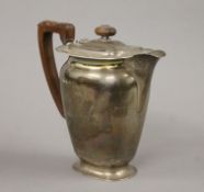 A silver coffee pot. 19 cm high. 709.7 grammes total weight.