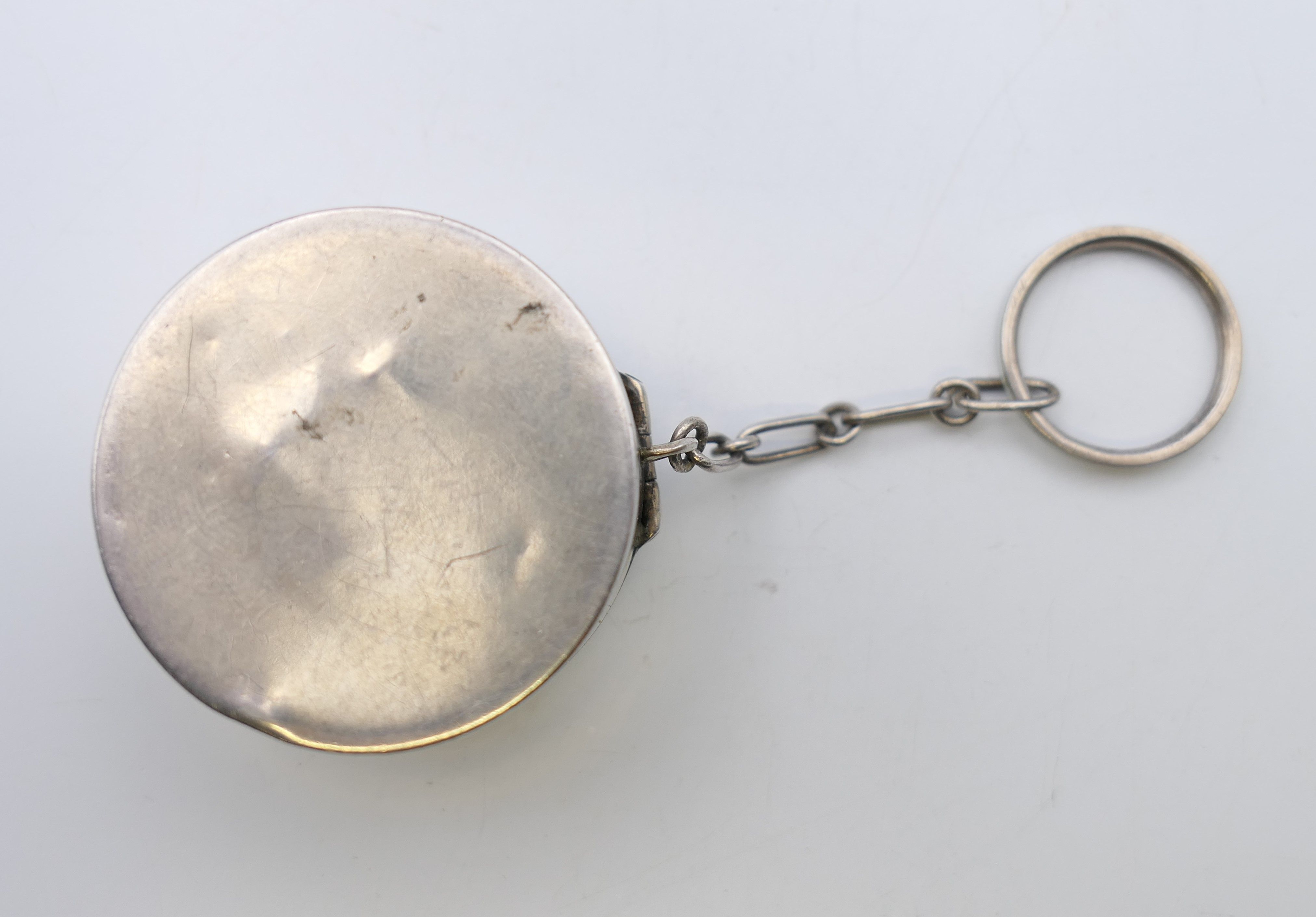 An early 20th century enamel decorated silver pill box. 4 cm diameter. - Image 4 of 5