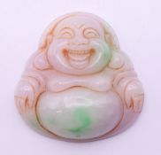 A jade pendant formed as Buddha. 5 cm high.