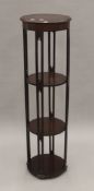 An Edwardian mahogany four tier circular jardiniere stand with pierced supports. 116 cm high.