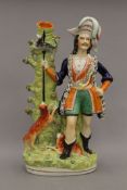 A large 19th century Staffordshire pottery spill figure, The Otter Hunter. 43.5 cm high.