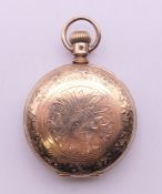 An Elgin gold plated pocket watch. 4 cm diameter.