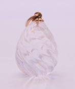 A 14 ct gold mounted crystal egg pendant. 2.75 cm high.