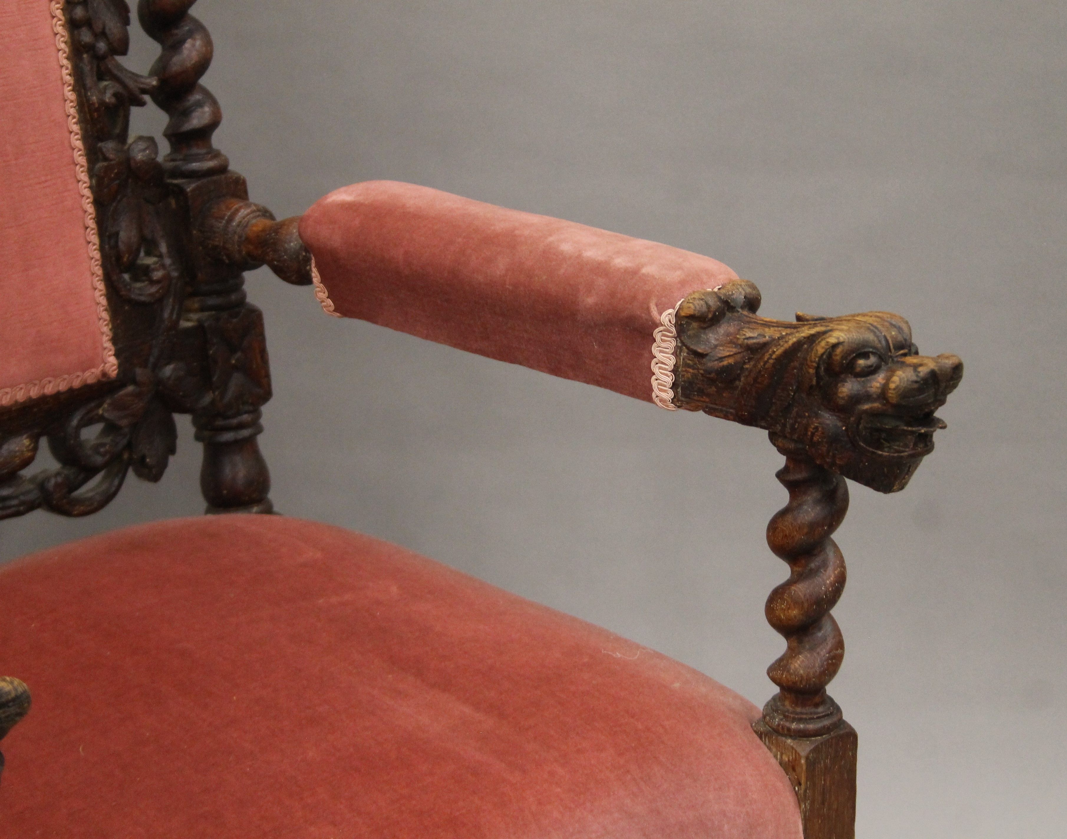 A 19th century carved oak upholstered open armchair with greenman back and dolphin form arms. - Image 4 of 7