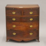 A miniature mahogany bow front chest of drawers. 40.5 cm wide x 44 cm high.