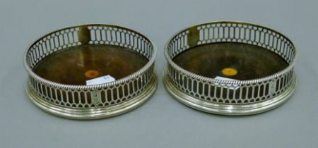A pair of Georgian silver bottle coasters. 12 cm diameter.